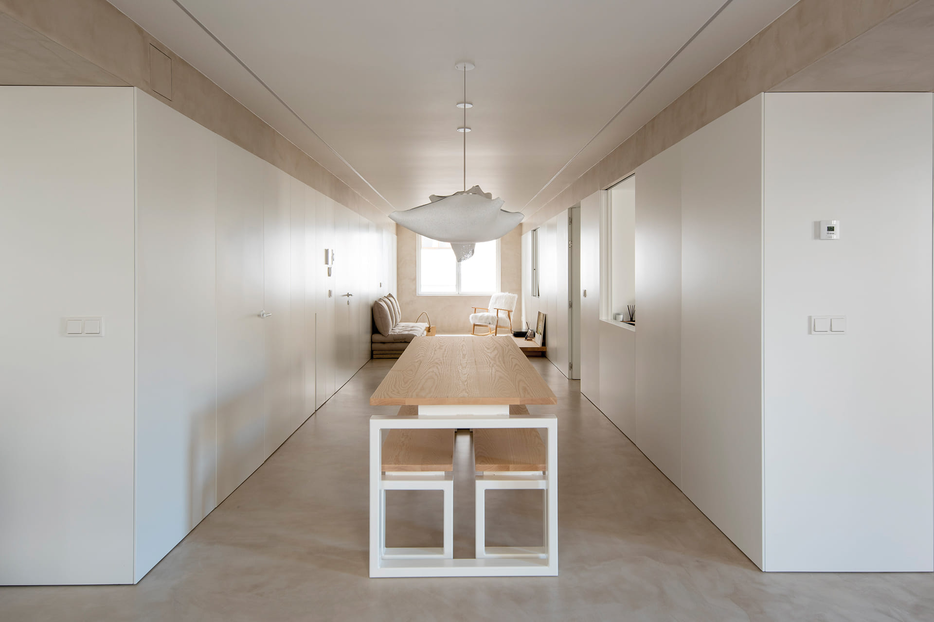 Dining area with white and wood table and benches