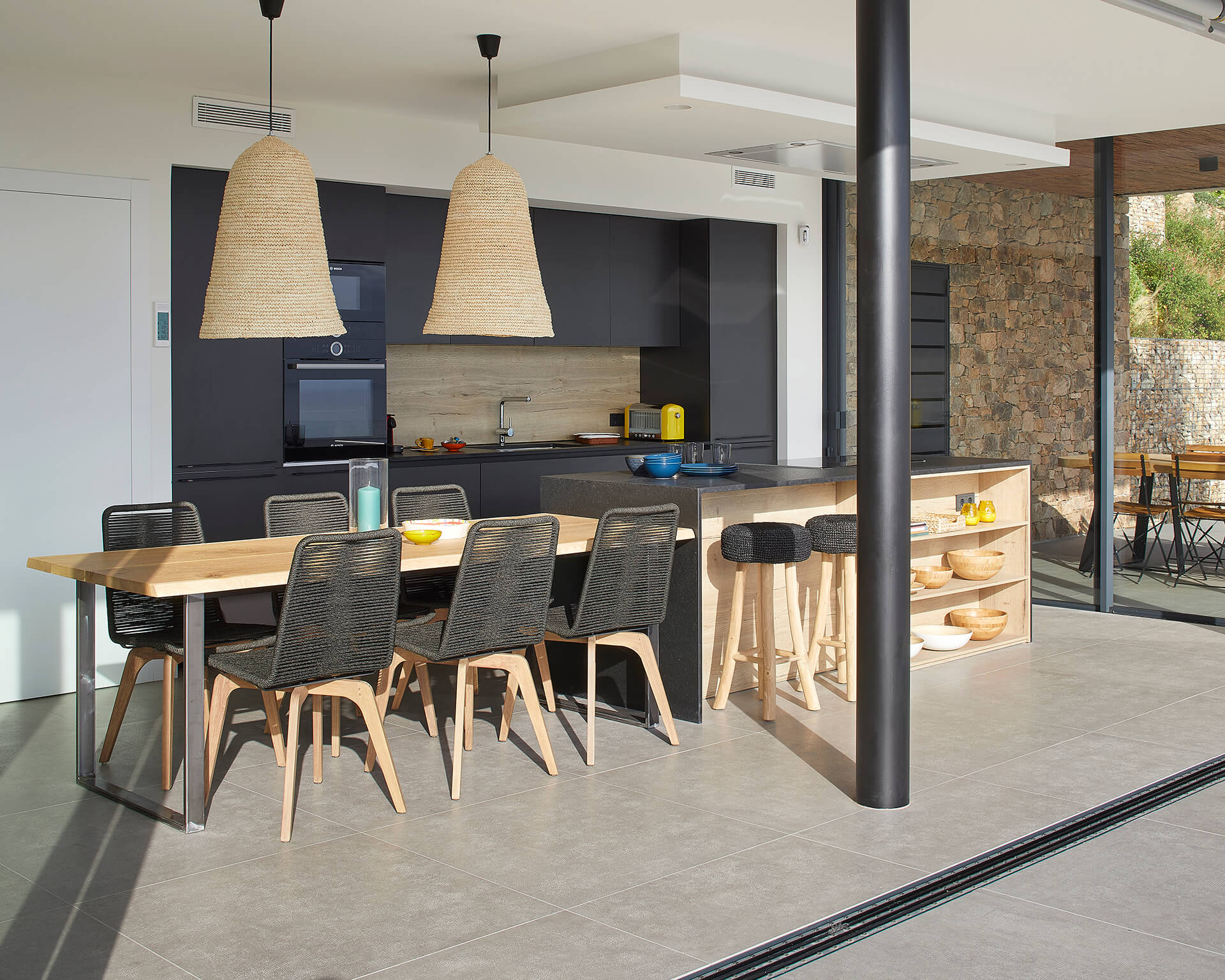 Santos kitchen finished in graphene and wood with island and dining room