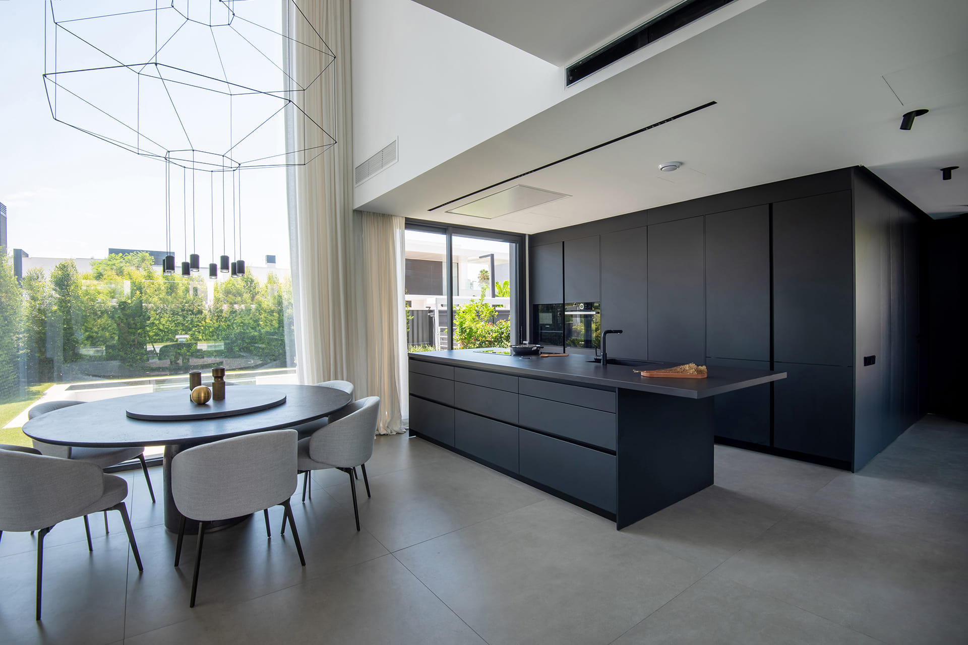 Home with black Santos kitchen open to the dining room