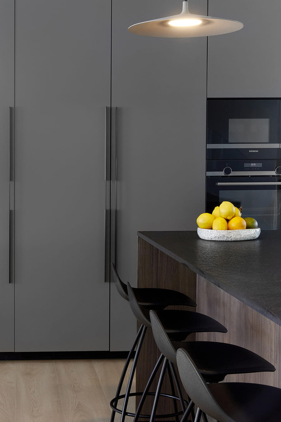Tall units in dark grey kitchen, Santos design with island.