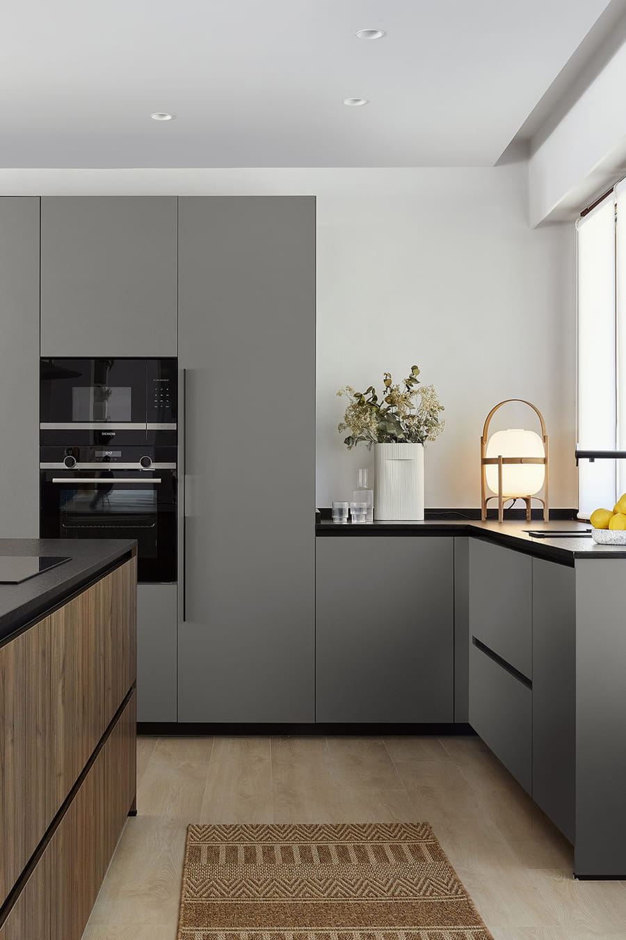 Grey kitchen with island and tall units, integrated appliances, Santos.