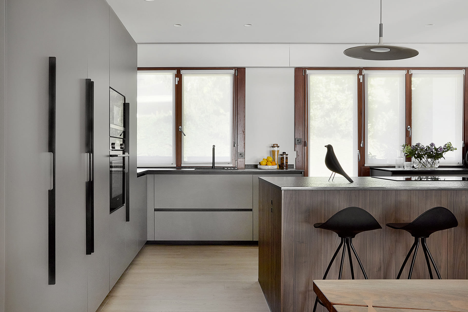 Grey kitchen with centre island and tall units, Santos design.