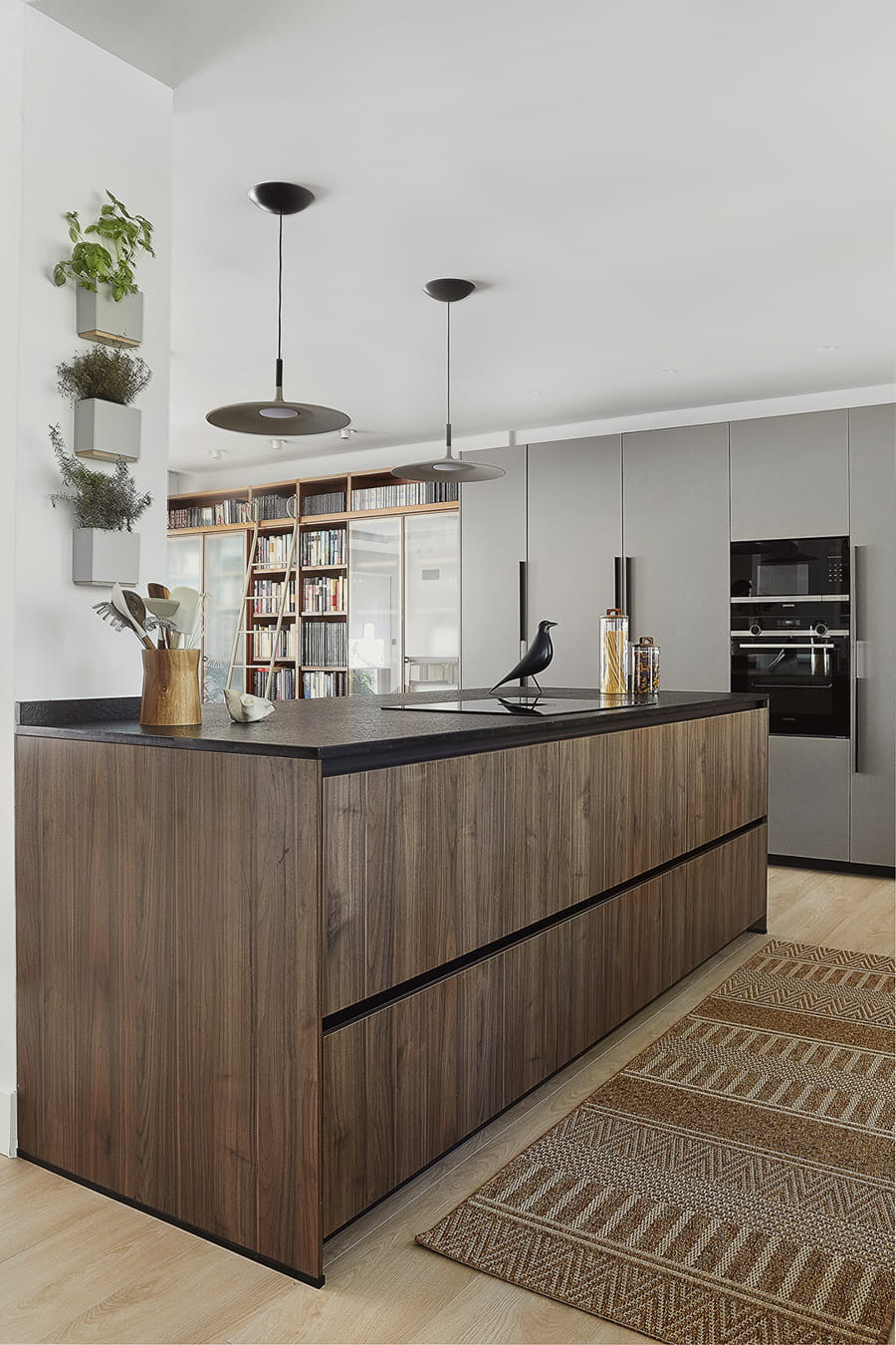 Centre island in grey and walnut wood kitchen, open-plan design, Santos.