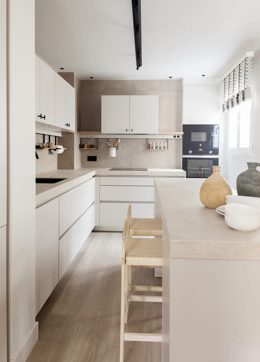 Cashmere Santos kitchen open to the lounge with an L-shaped layout and counter.