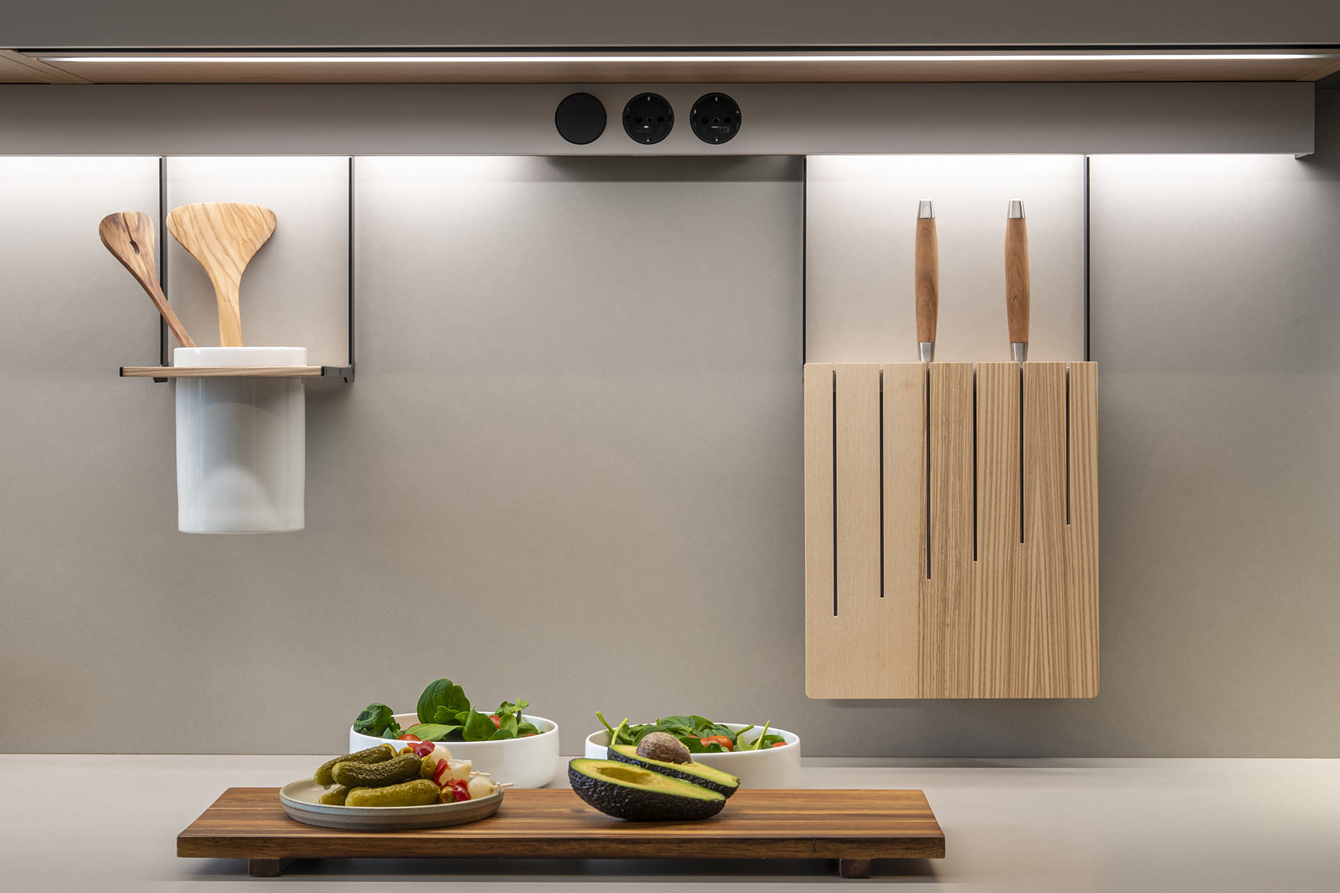 Close-up of the worktop with utility units and plug sockets in a Cashmere Santos kitchen.