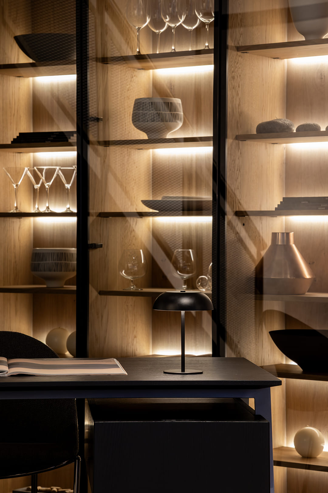 Glass door unit with interior lighting at the Santos kitchen showroom in Girona.