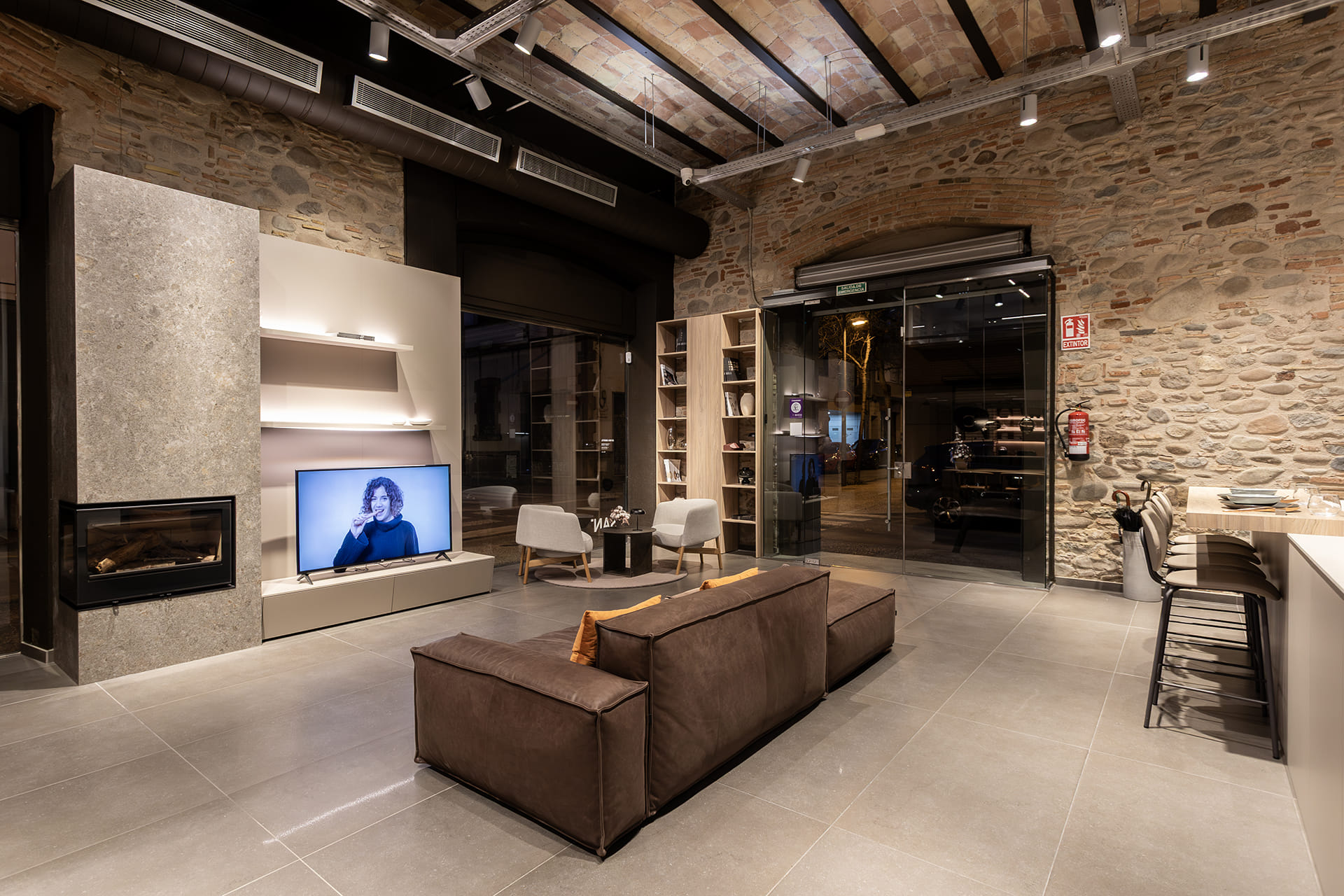 Living zone with bookcase at the back at the Santos showroom in Girona.