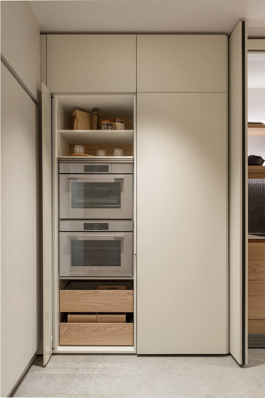 Retractable units with integrated appliances at the Santos Kitchens showroom in Switzerland.