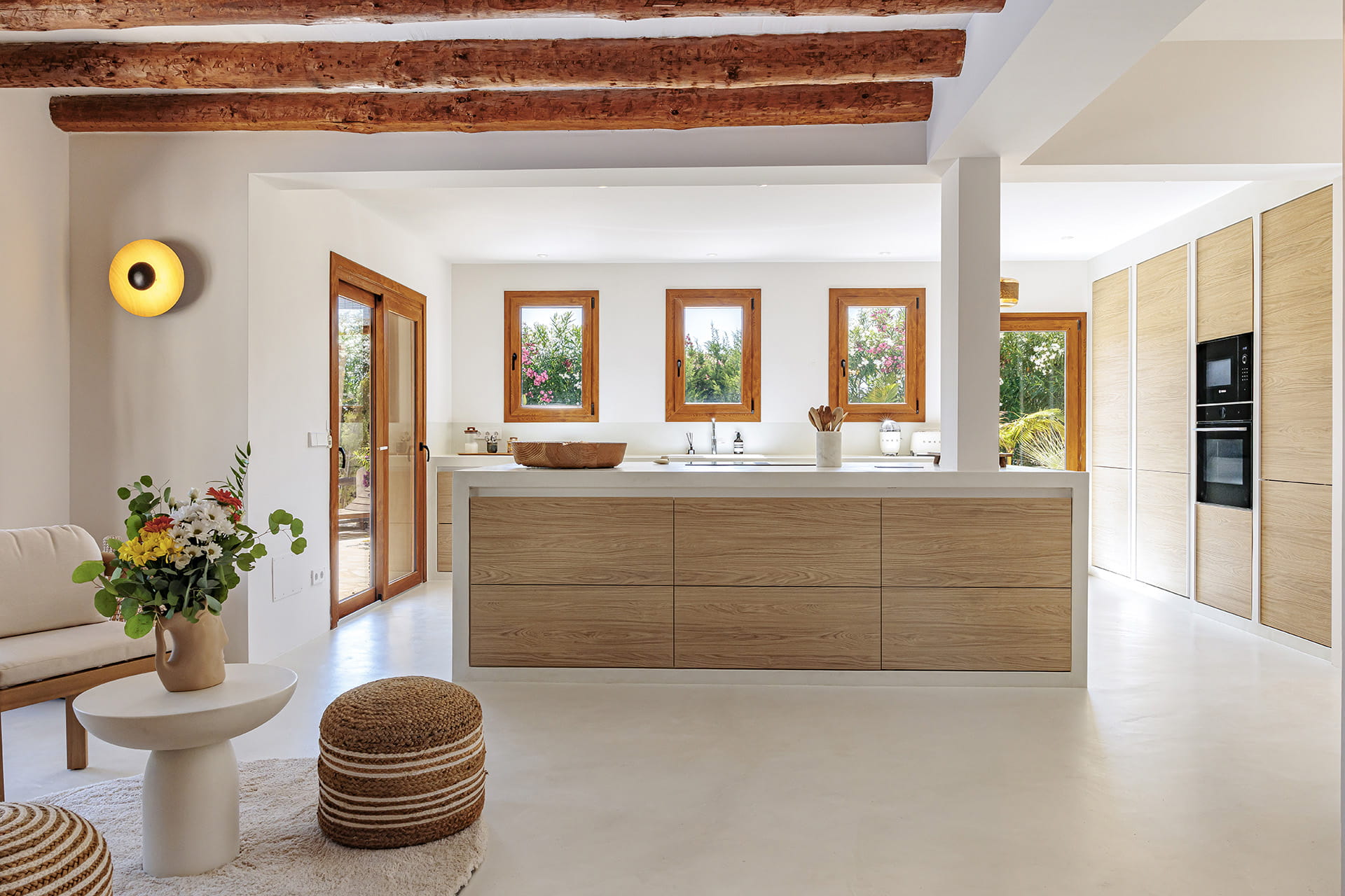 White and wood kitchen open to the outdoor area designed by Santos Kitchens.