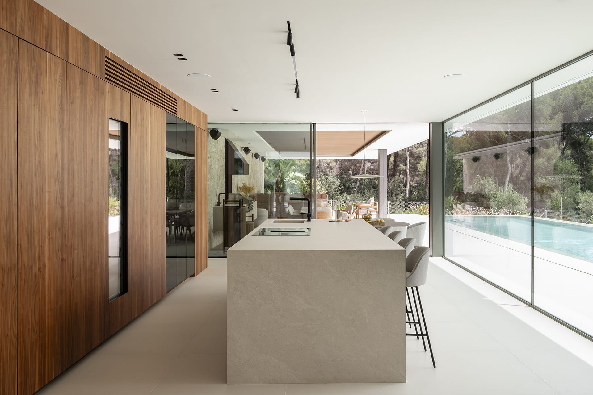 White and wood kitchen open to the outdoor area designed by Santos Kitchens.
