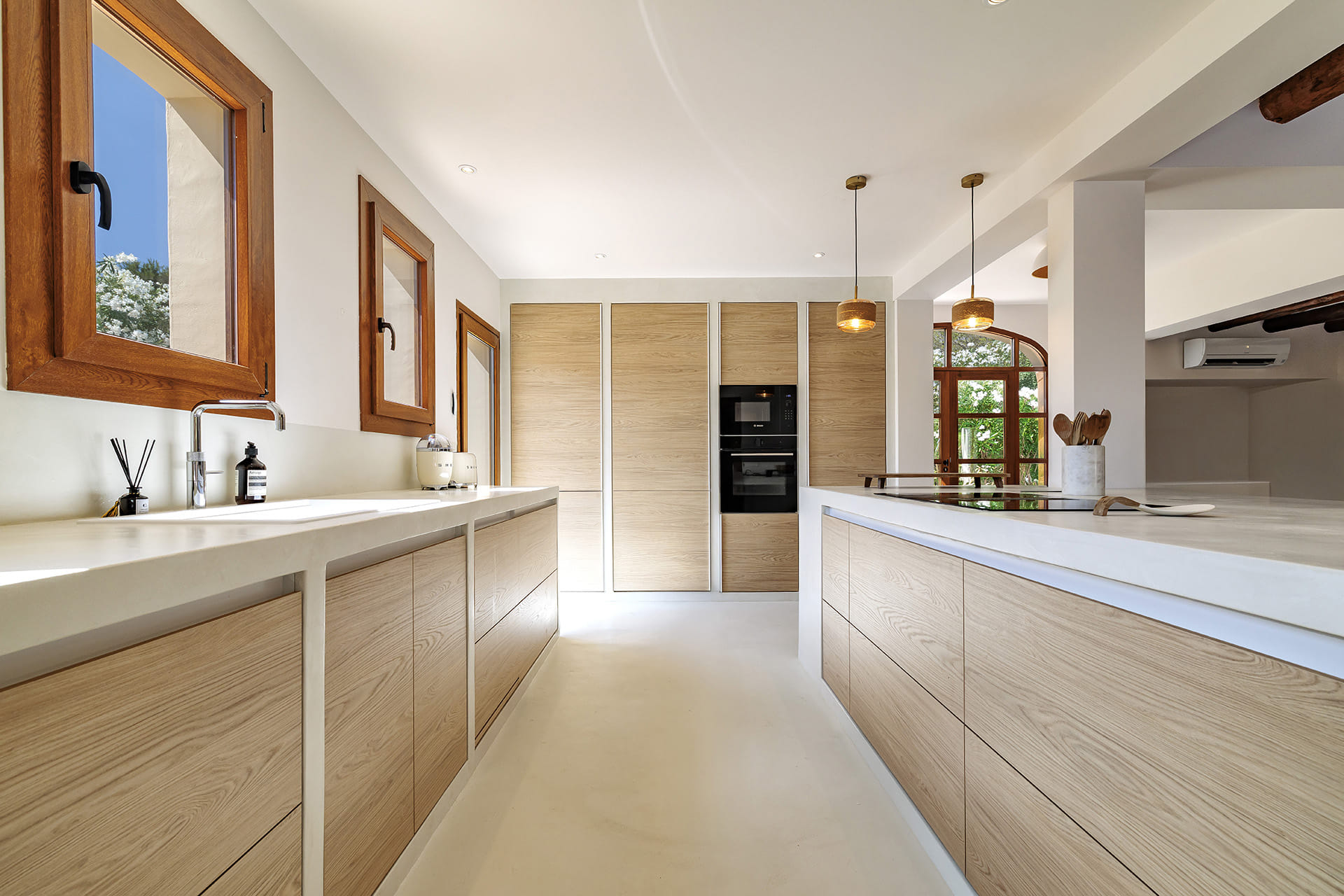 Santos kitchen with tall units and integrated appliances.