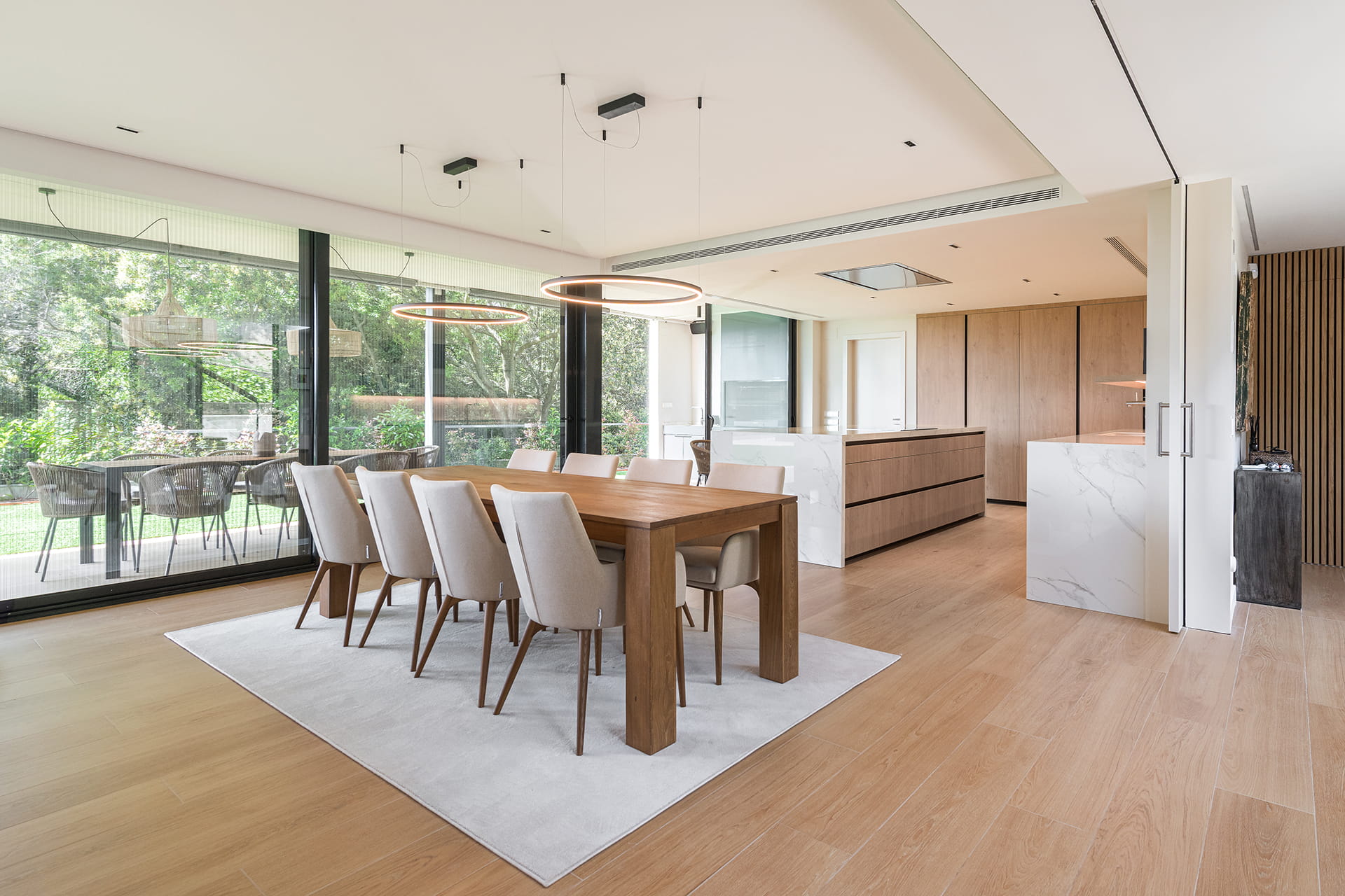 Dining area and outdoor area in a home with a Santos kitchen.