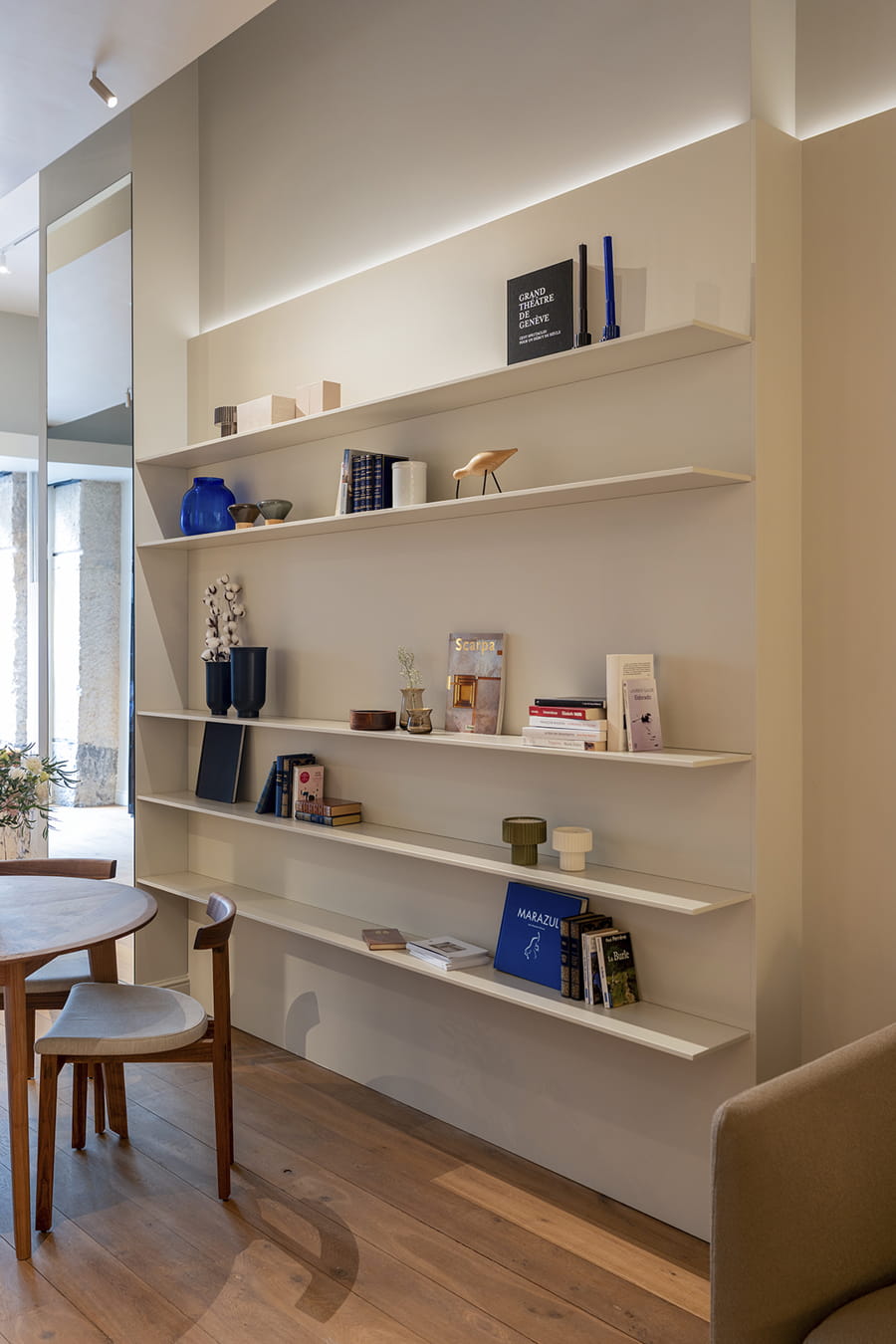 White shelves in the living area at the Santos Kitchens showroom in Switzerland.