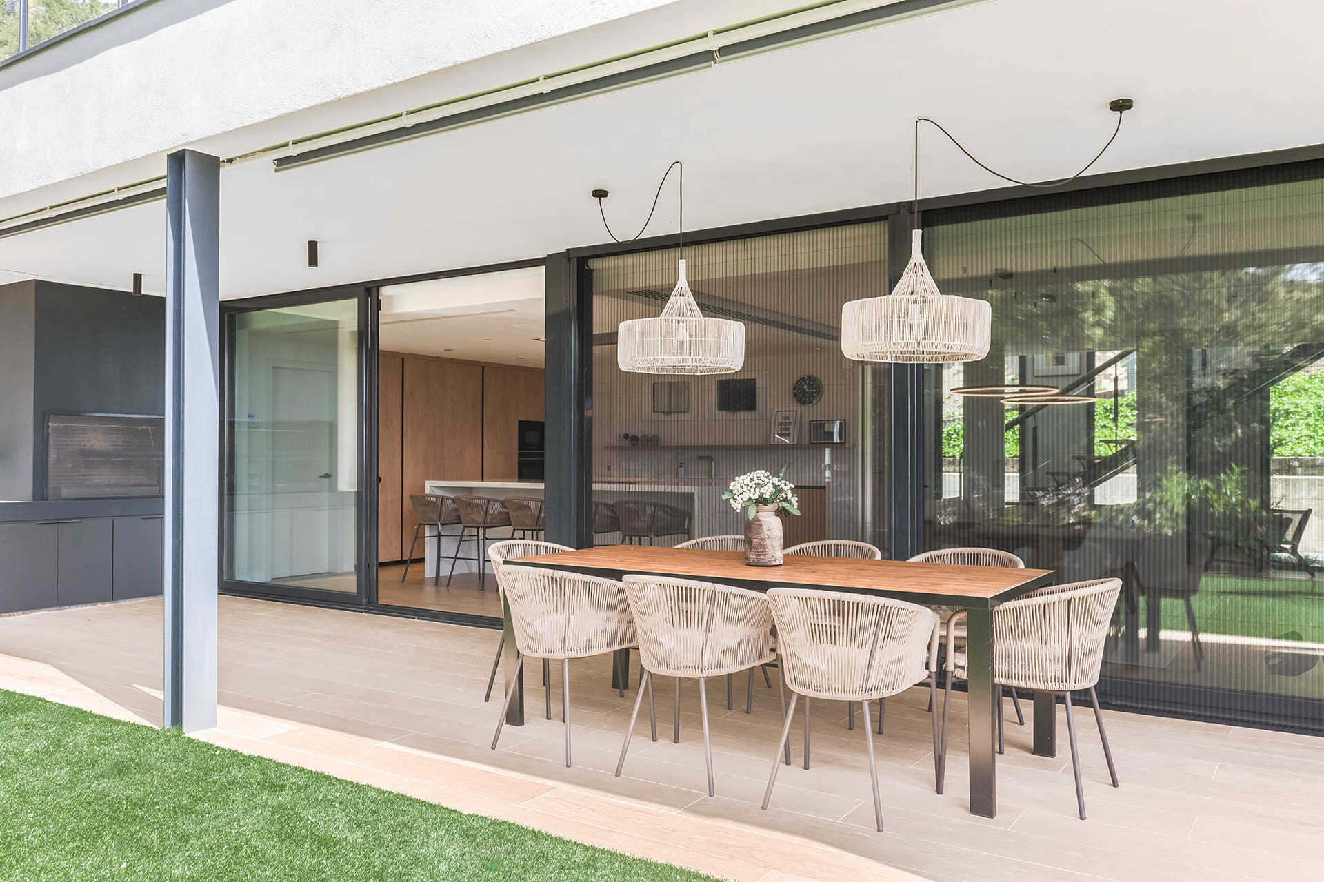 Outdoor area with table and chairs in a home with a Santos kitchen.