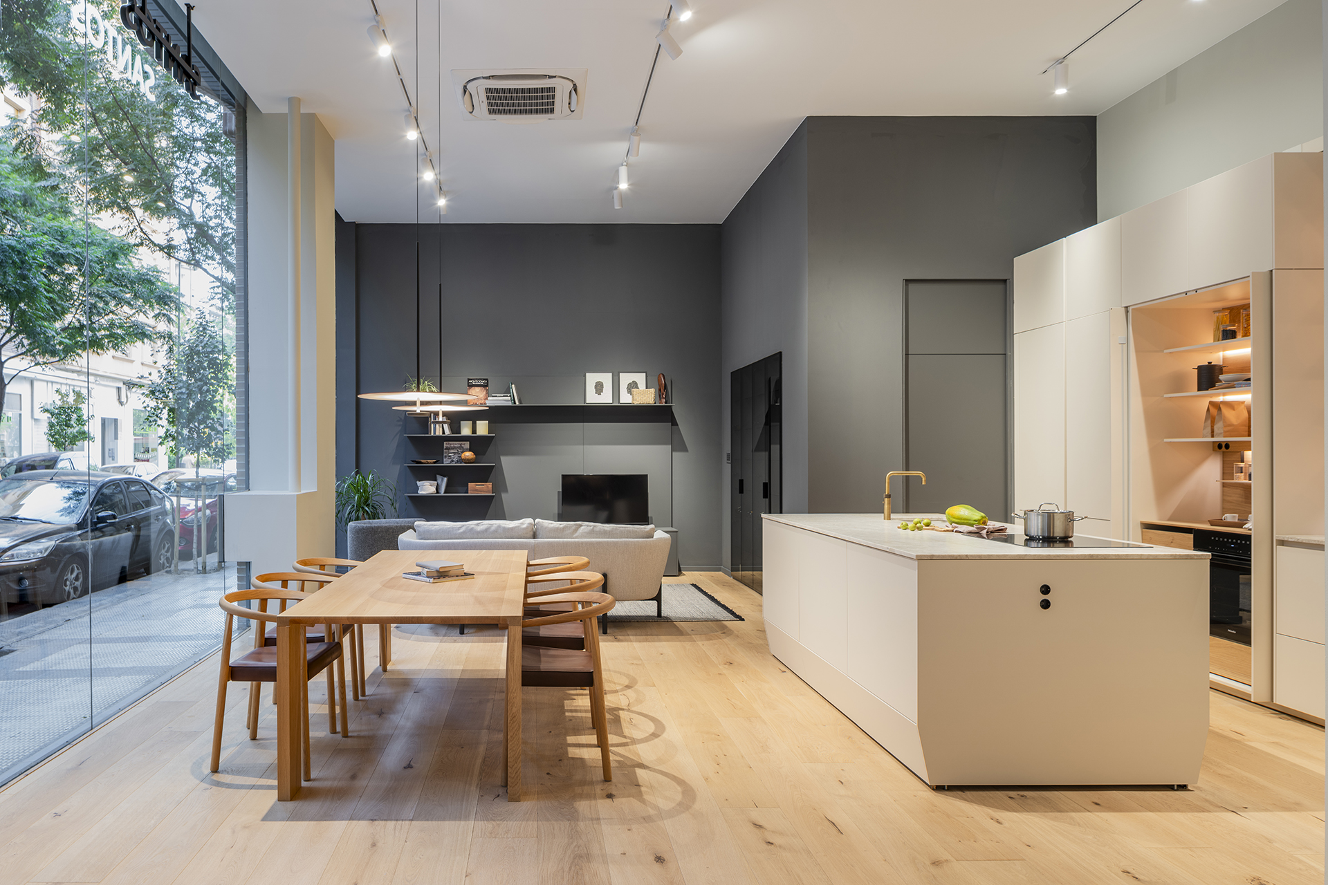 Cocina con isla y sala de estar en la nueva tienda de cocinas Santos en Zaragoza.