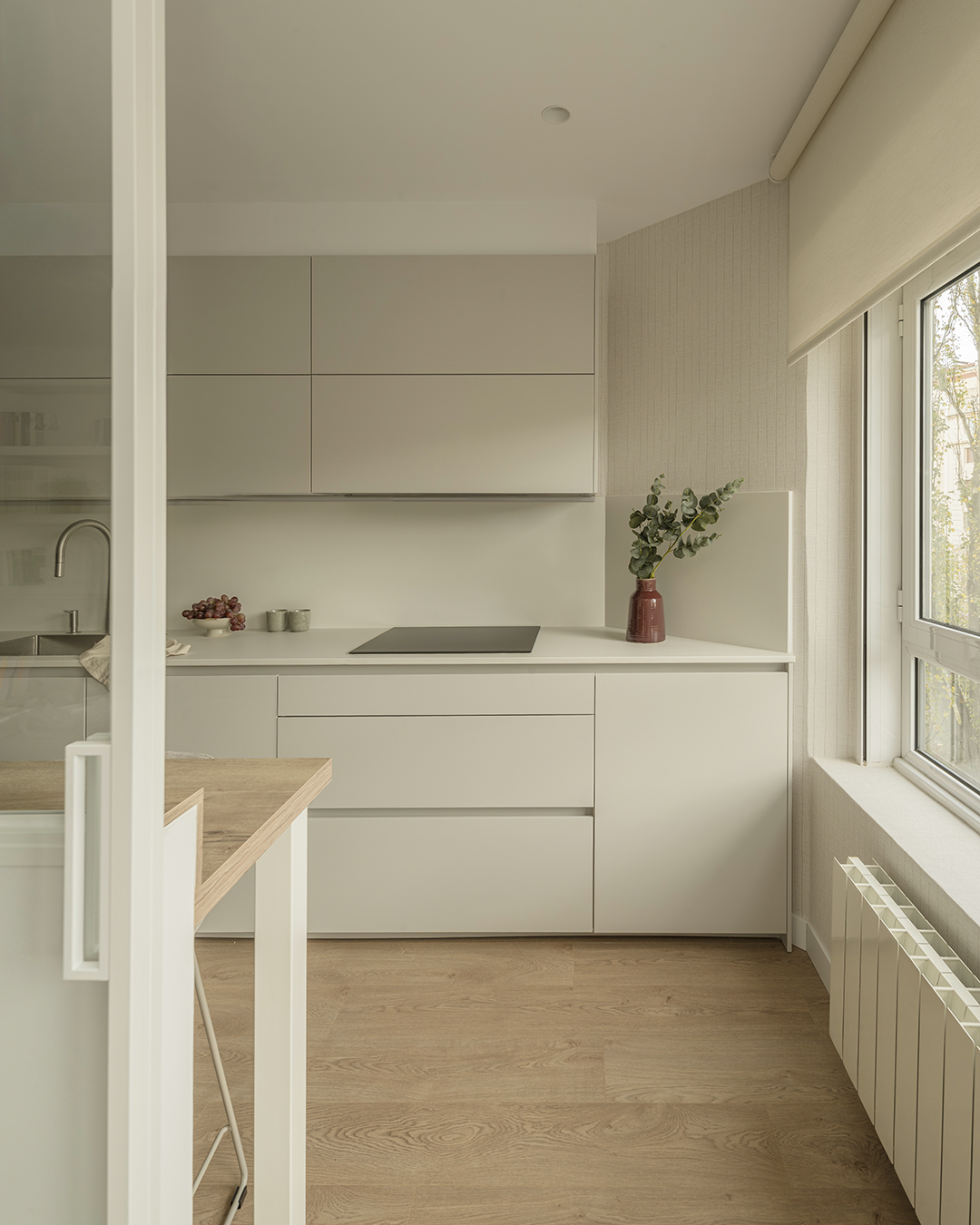 Cocina gris con cerramiento acristalado y barra de madera Santos.
