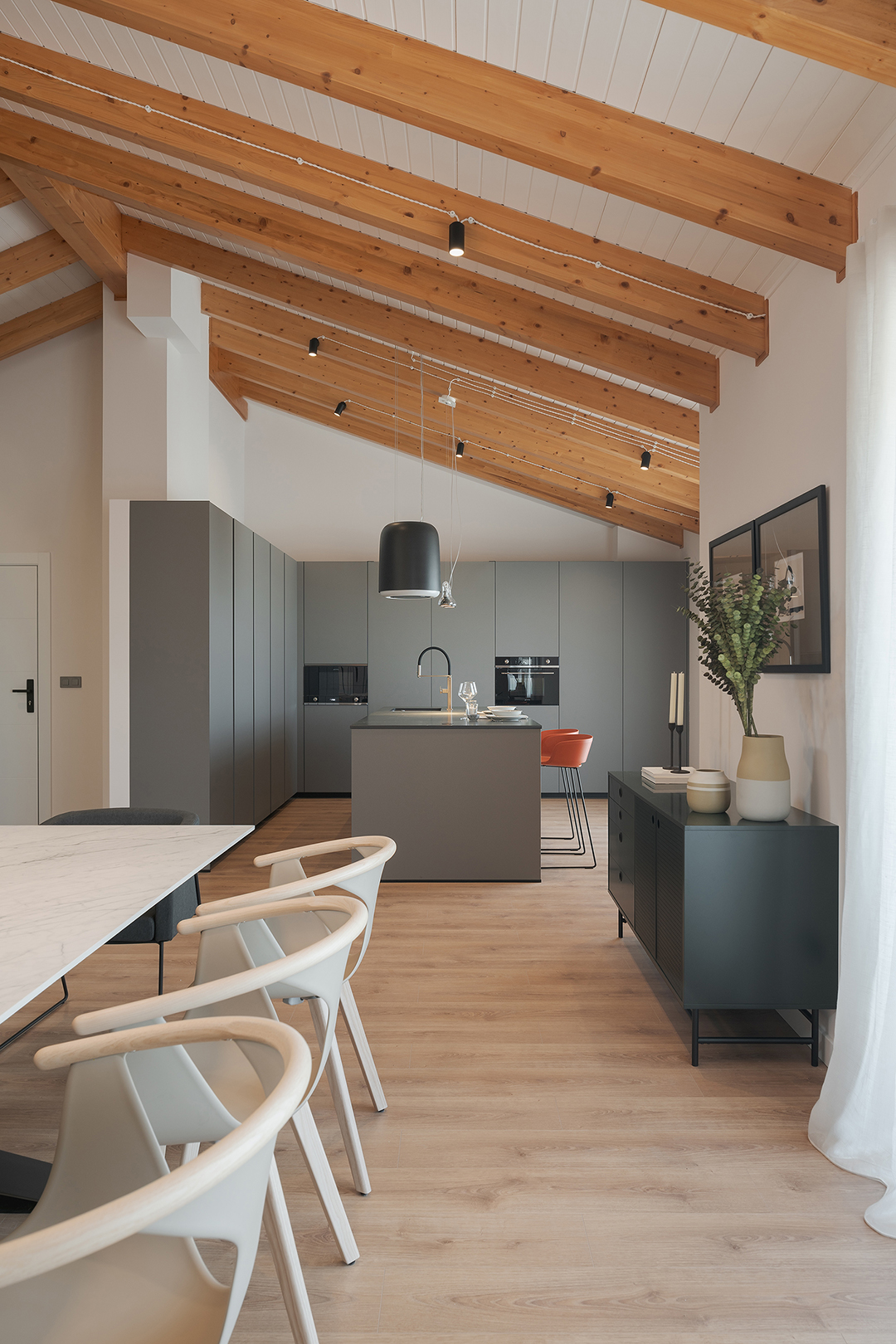 Cocina gris con isla abierta al salón diseñada por Santos.